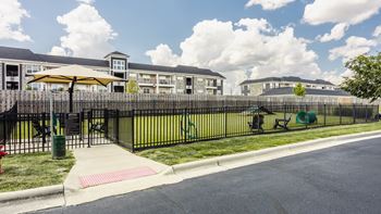A sunny day at a residential area with apartment buildings and a playground